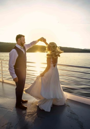 Bride and Groom dancing on deck in the sunset